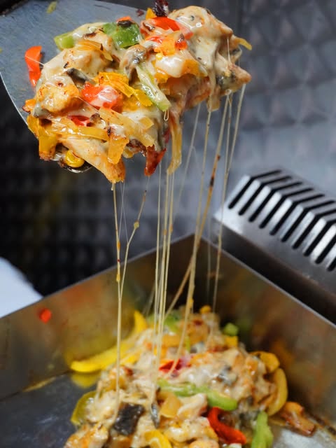 Cheesy shawarma fresh from the grill at Albeek Manchester