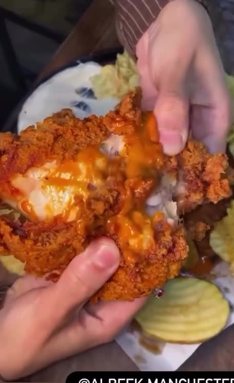 Albeek injected crispy chicken opened to reveal its juicy filling
